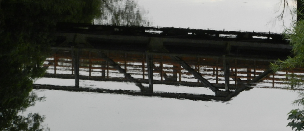A reflection of a bridge in the river Swale