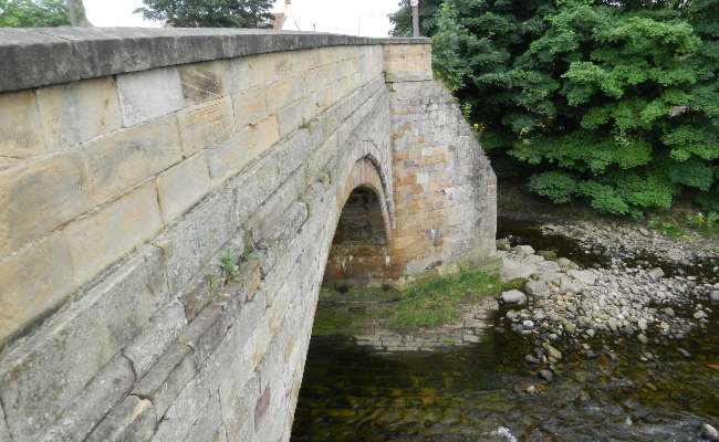 An old stone bridge over a river